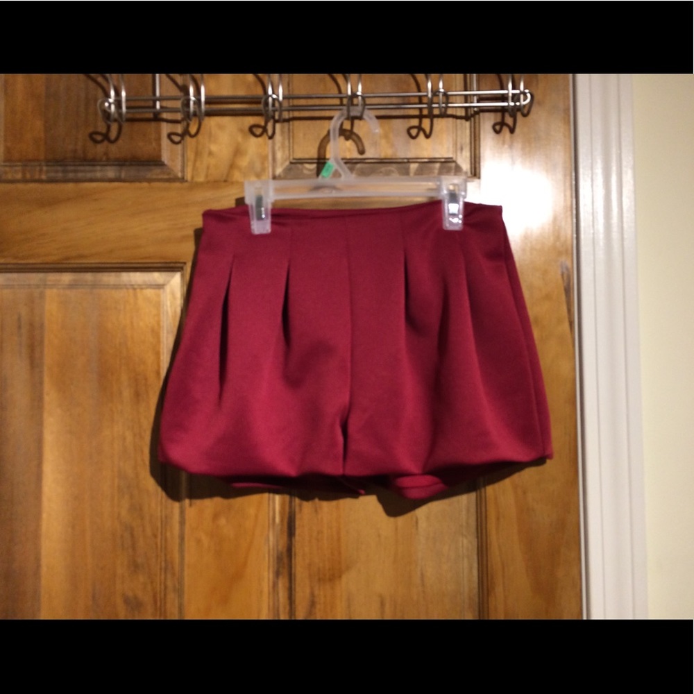 pair of puffy maroon zipped up shorts